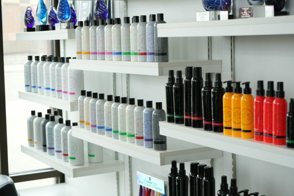 Shelves stocked with rows of haircare products in a salon