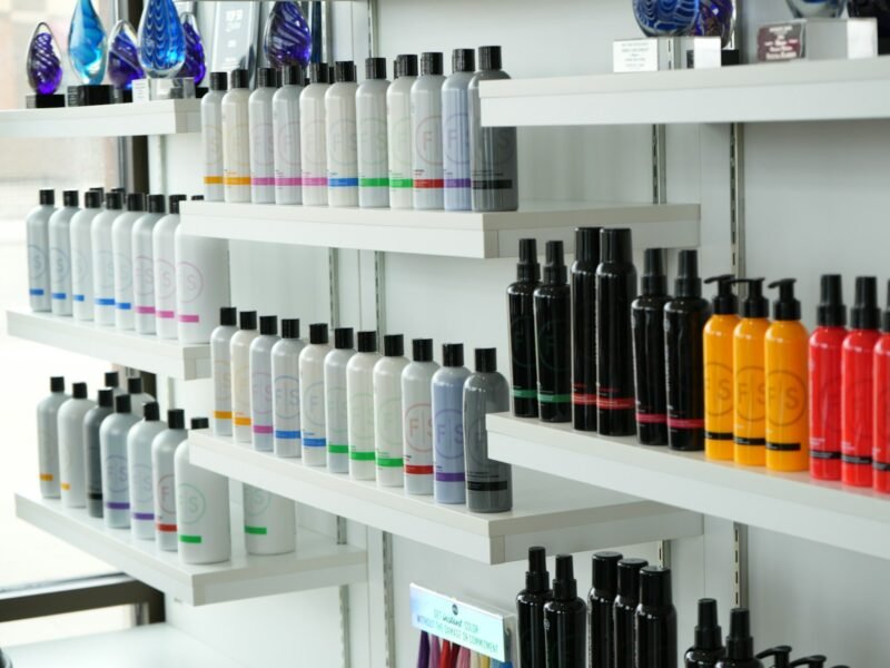 Shelves stocked with rows of haircare products in a salon