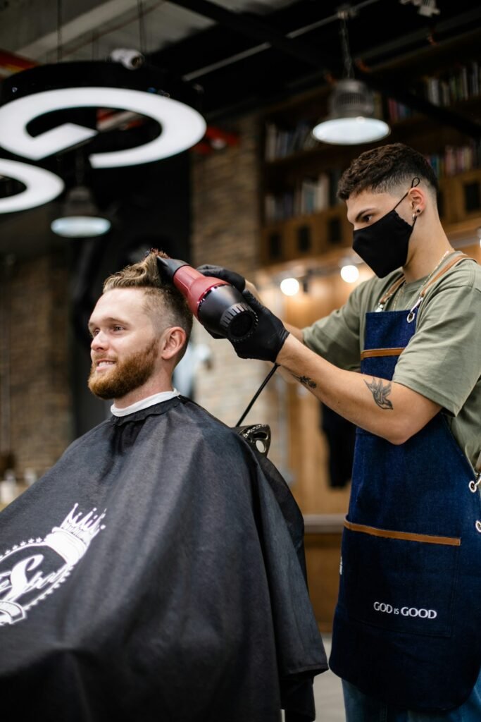Close fade and textured crop being finished in a barber shop